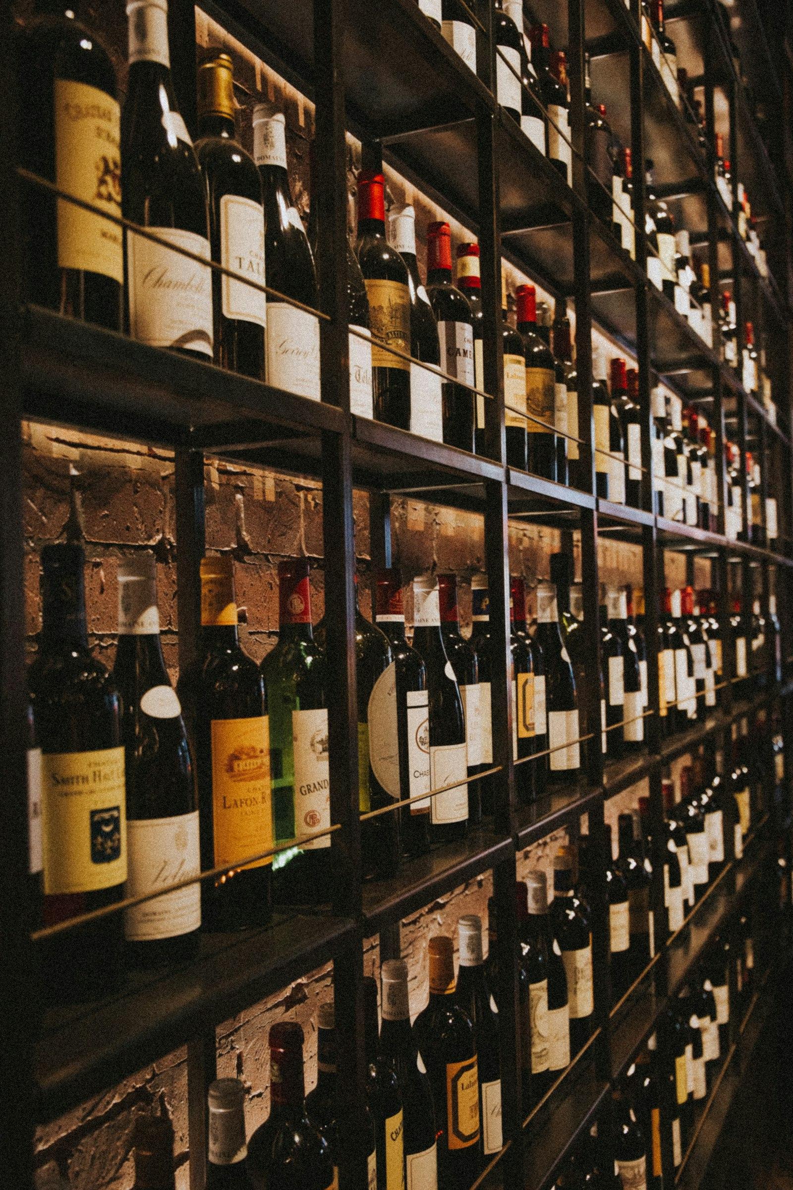 Floor-to-ceiling shelving of wine bottles in a wine shop